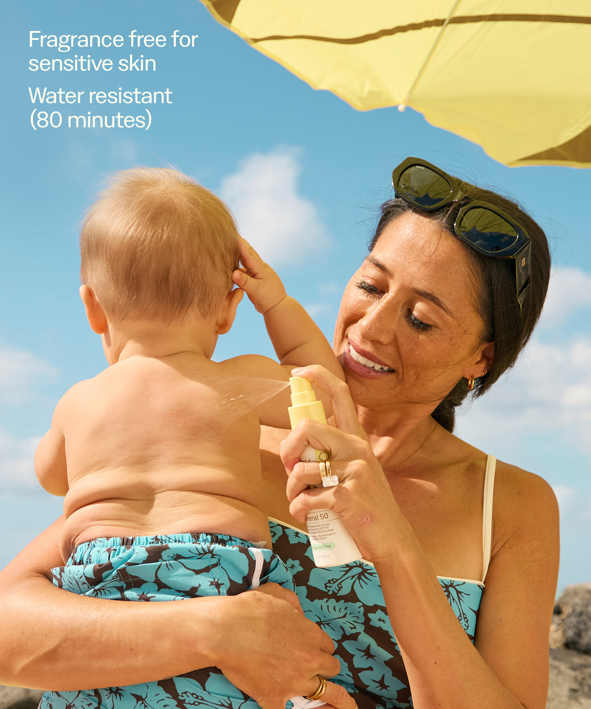Woman applying sunscreen to a child on a beach with text about product features.