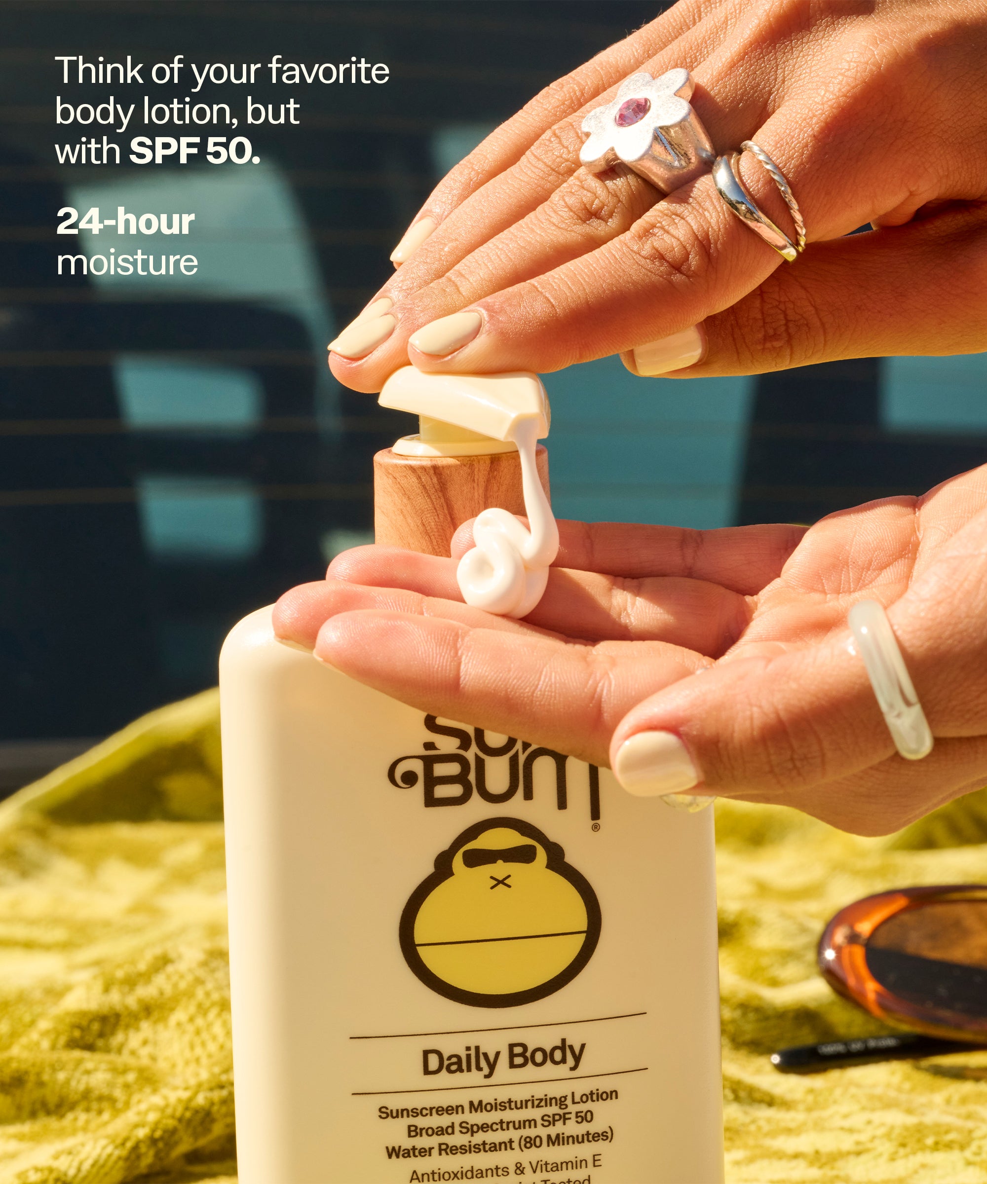 Person applying Sun Bum Daily Body sunscreen lotion with SPF 50 on a blurred outdoor background.