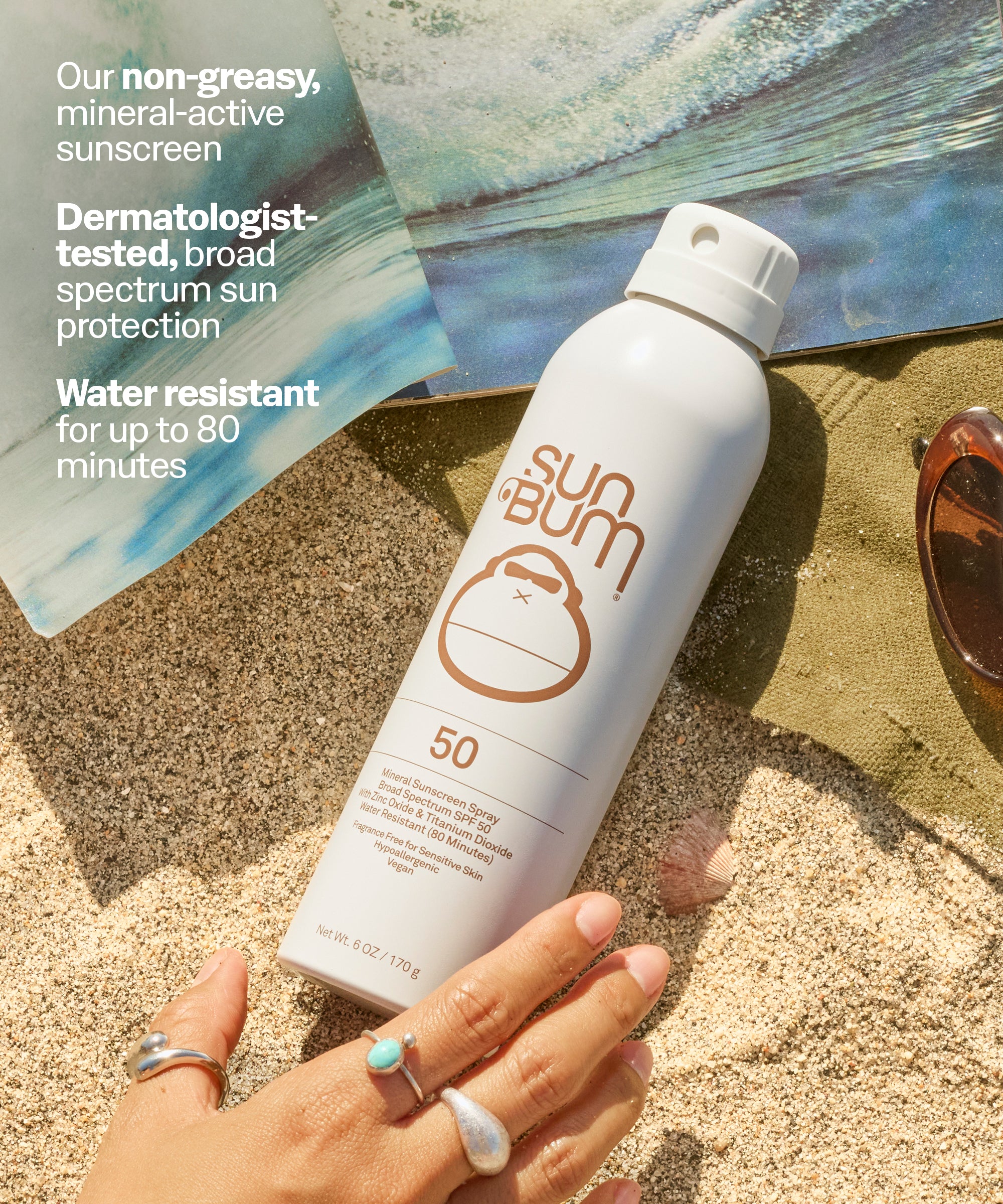 Sun Bum sunscreen bottle on sand with promotional text