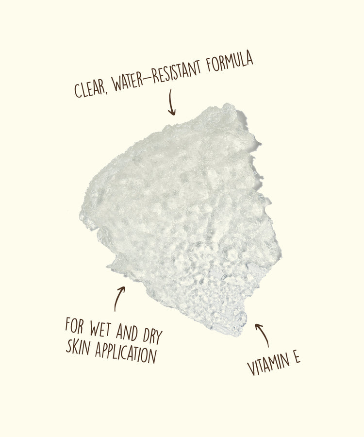 White powdery substance with text indicating clear, water-resistant formula, wet and dry skin application, and vitamin E.