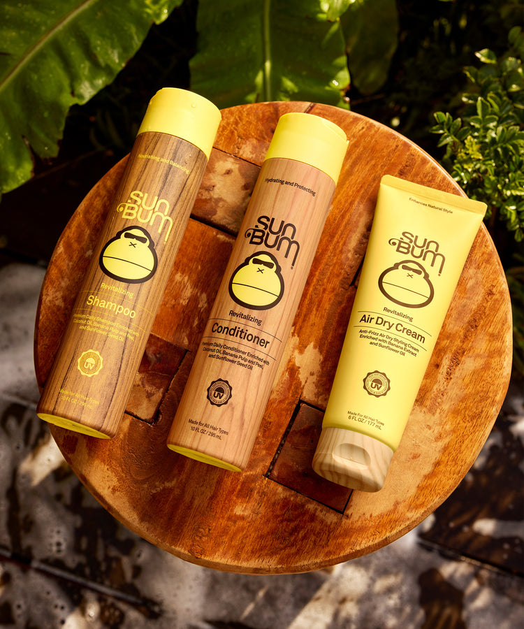 Sun Bum hair care products on a wooden surface with natural background