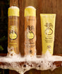 Sun Bum hair care products including shampoo, conditioner, and hair mask on a wooden surface.