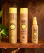 Sun Bum shampoo, conditioner, and leave-in product on a wooden shelf with a wooden background.
