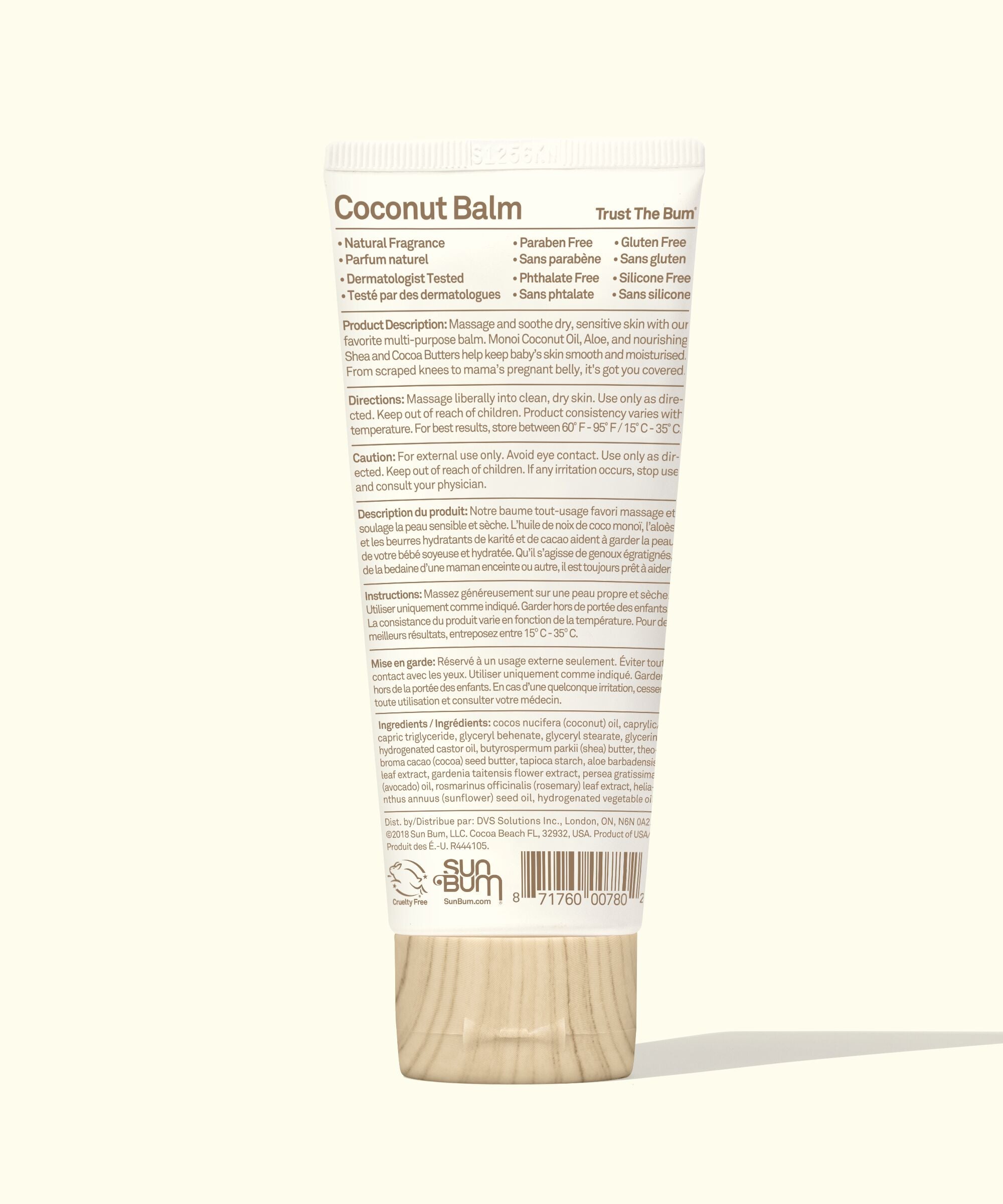 Coconut balm container with wooden applicator on a white background