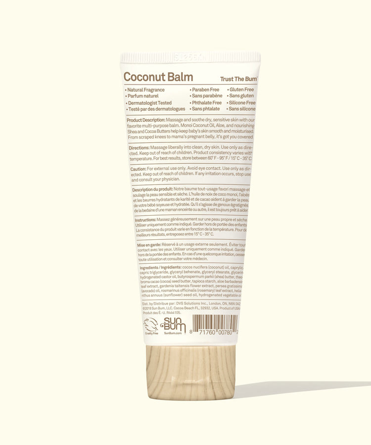 Coconut balm container with wooden applicator on a white background