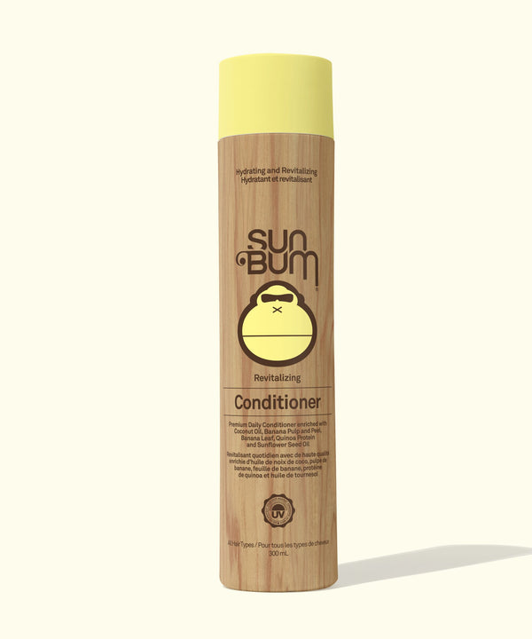 Sun Bum conditioner bottle with yellow cap on a white background