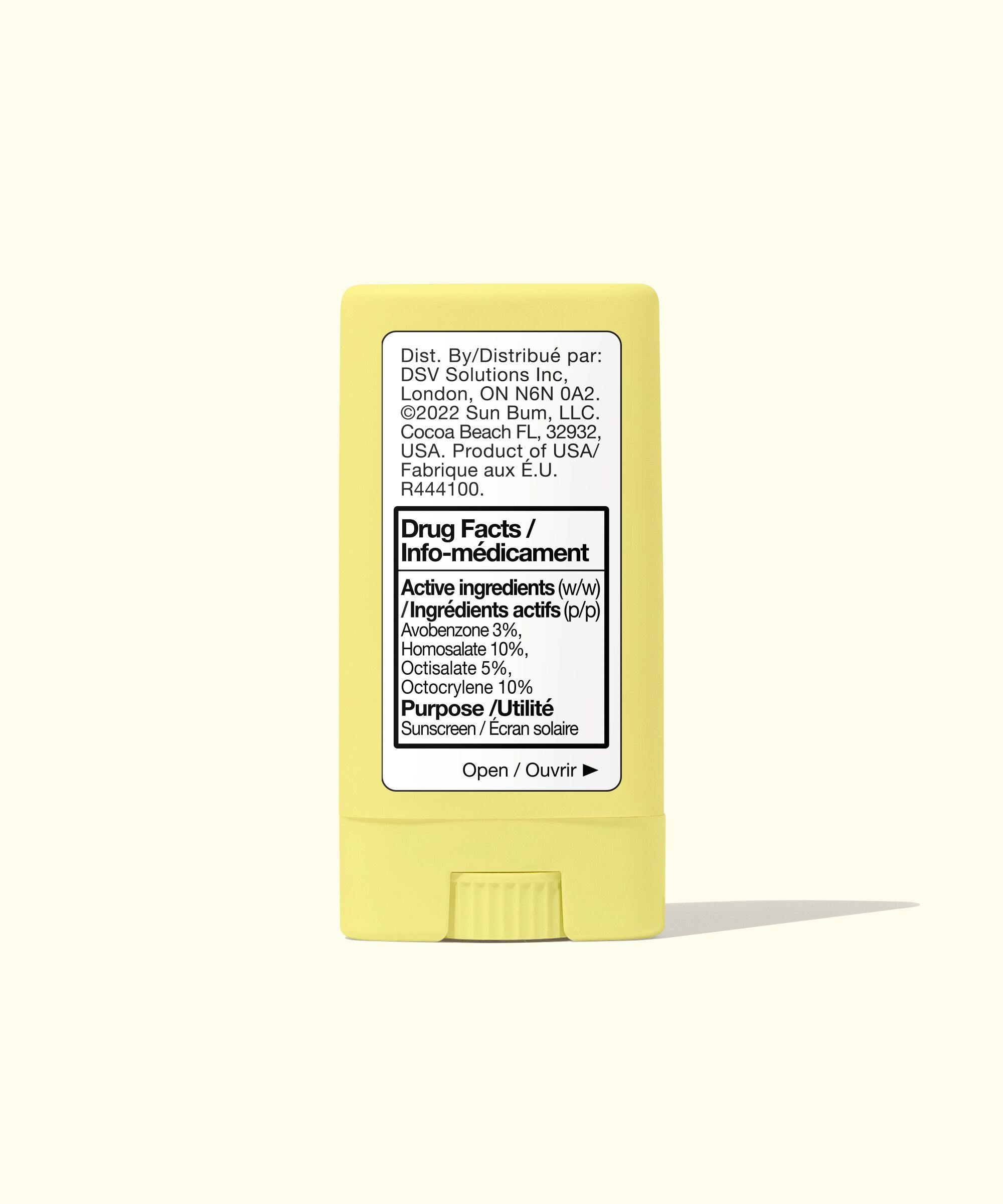 Yellow stick of sunscreen with label on a white background