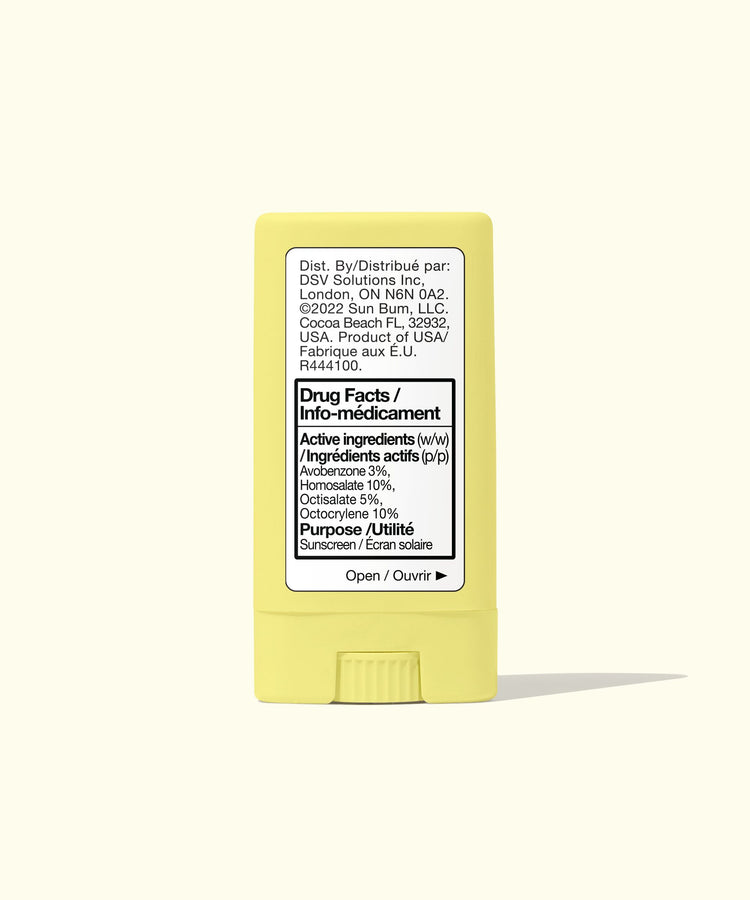 Yellow stick of sunscreen with label on a white background