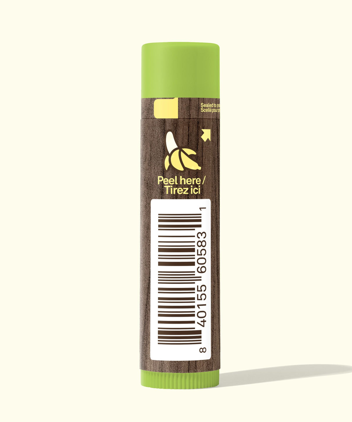 Lip balm with green cap and brown body on a white background