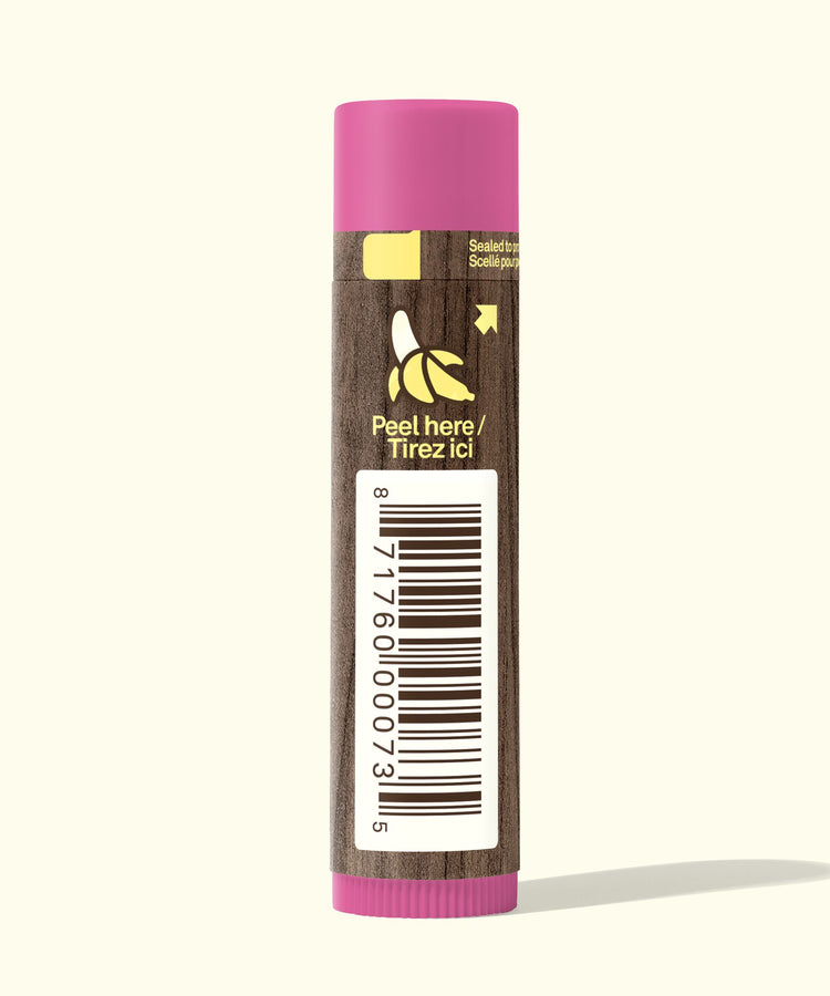 Lip balm with pink cap and brown body on a white background