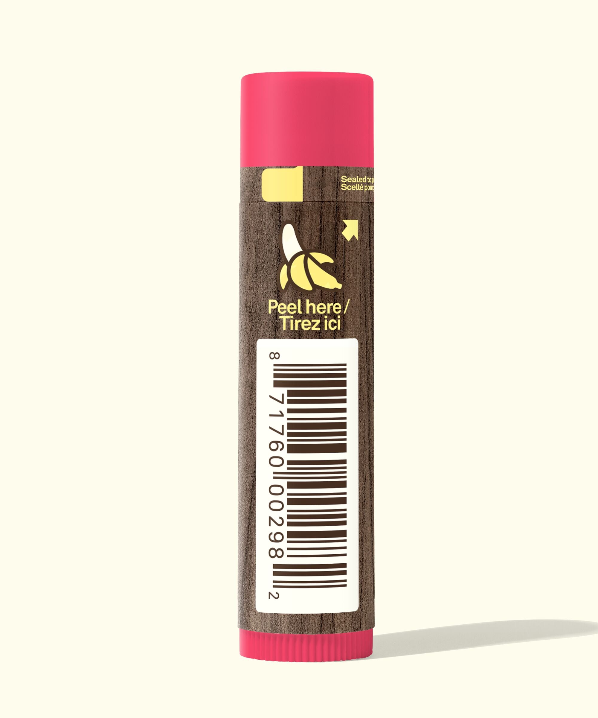 Lip balm with pink cap and brown body on a white background