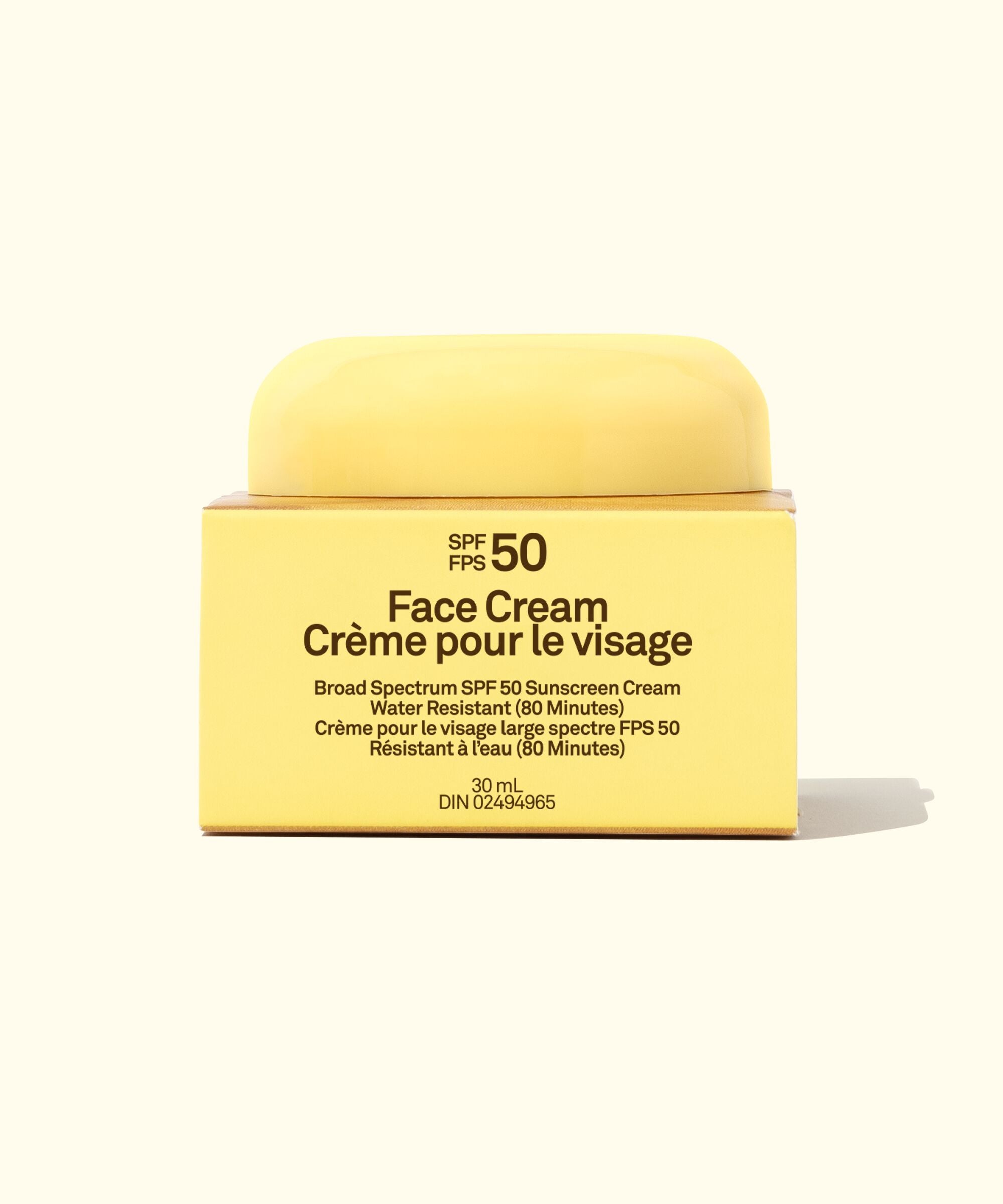 Yellow face cream jar with SPF 50 label on a white background
