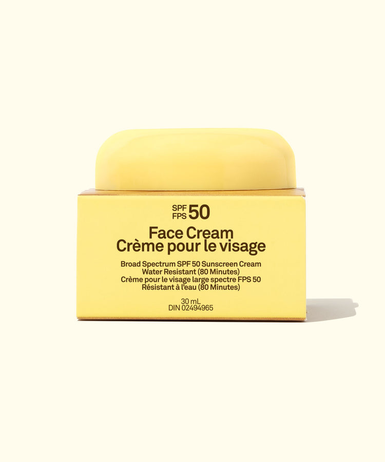 Yellow face cream jar with SPF 50 label on a white background