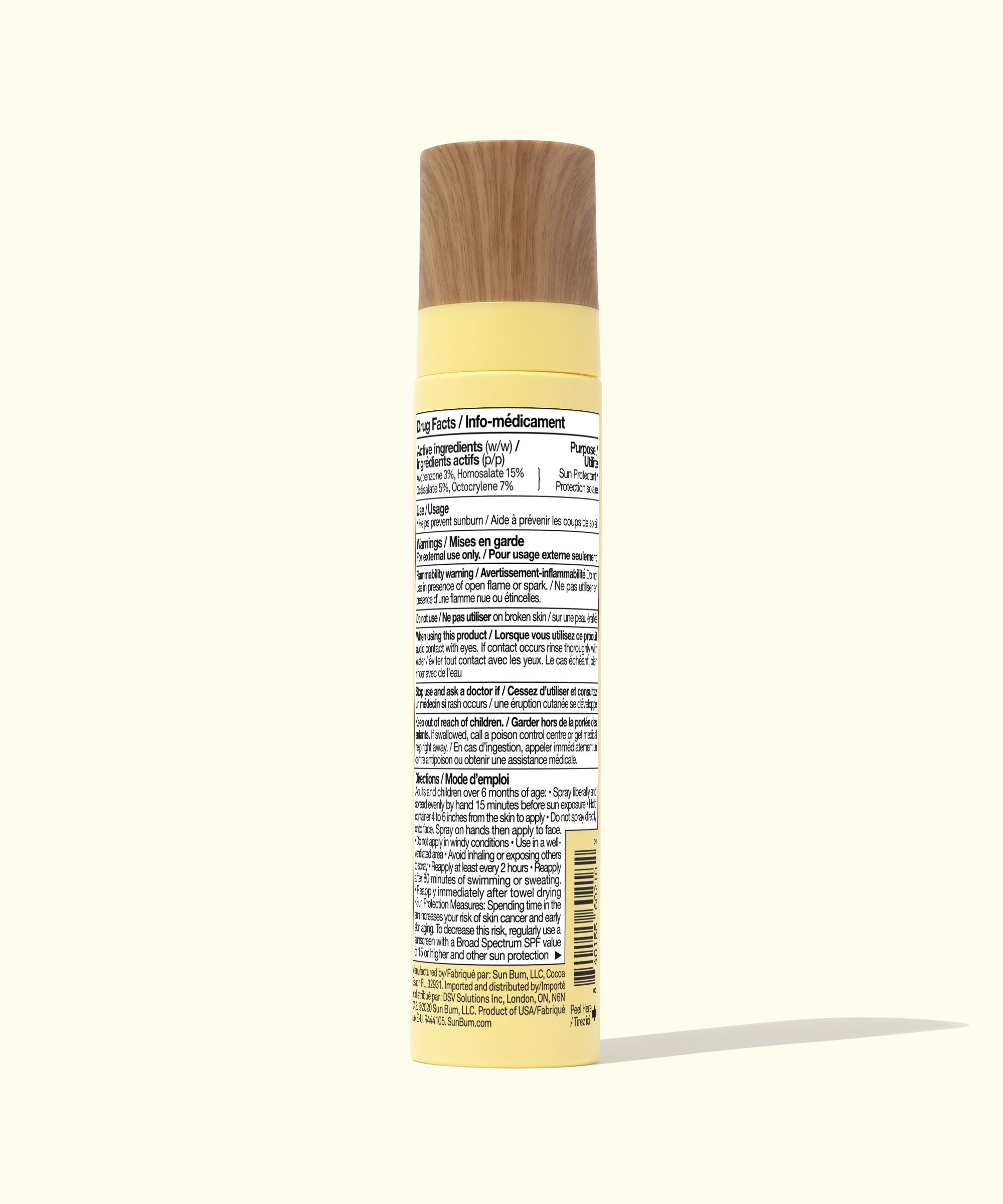 Yellow spray bottle with a wooden nozzle on a white background