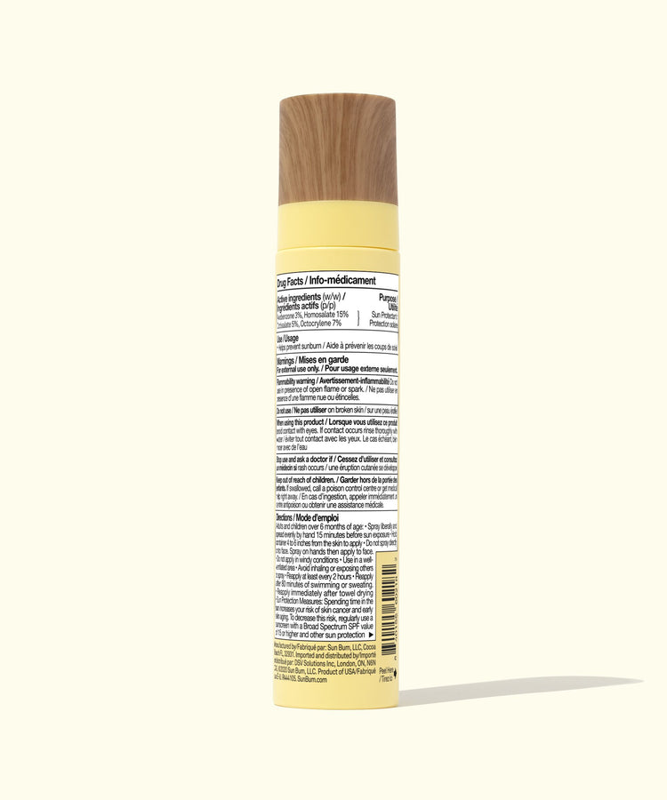 Yellow spray bottle with a wooden nozzle on a white background