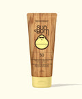 Sun Bum sunscreen tube with wooden texture and yellow cap on a white background