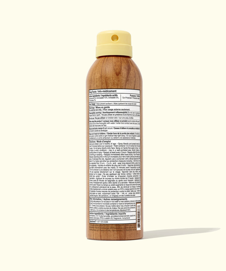 Wooden spray bottle with a beige cap on a white background