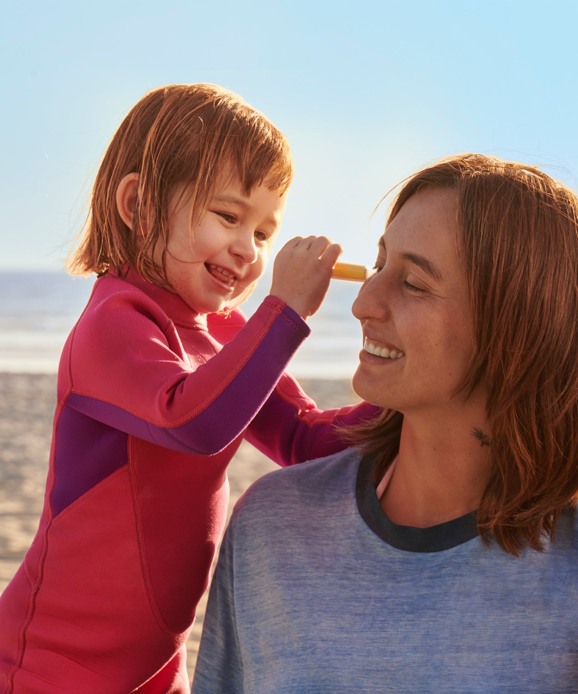 Woman and child on a beach with ocean view