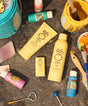 Sun Bum sunscreen products on a textured surface with tools and containers.