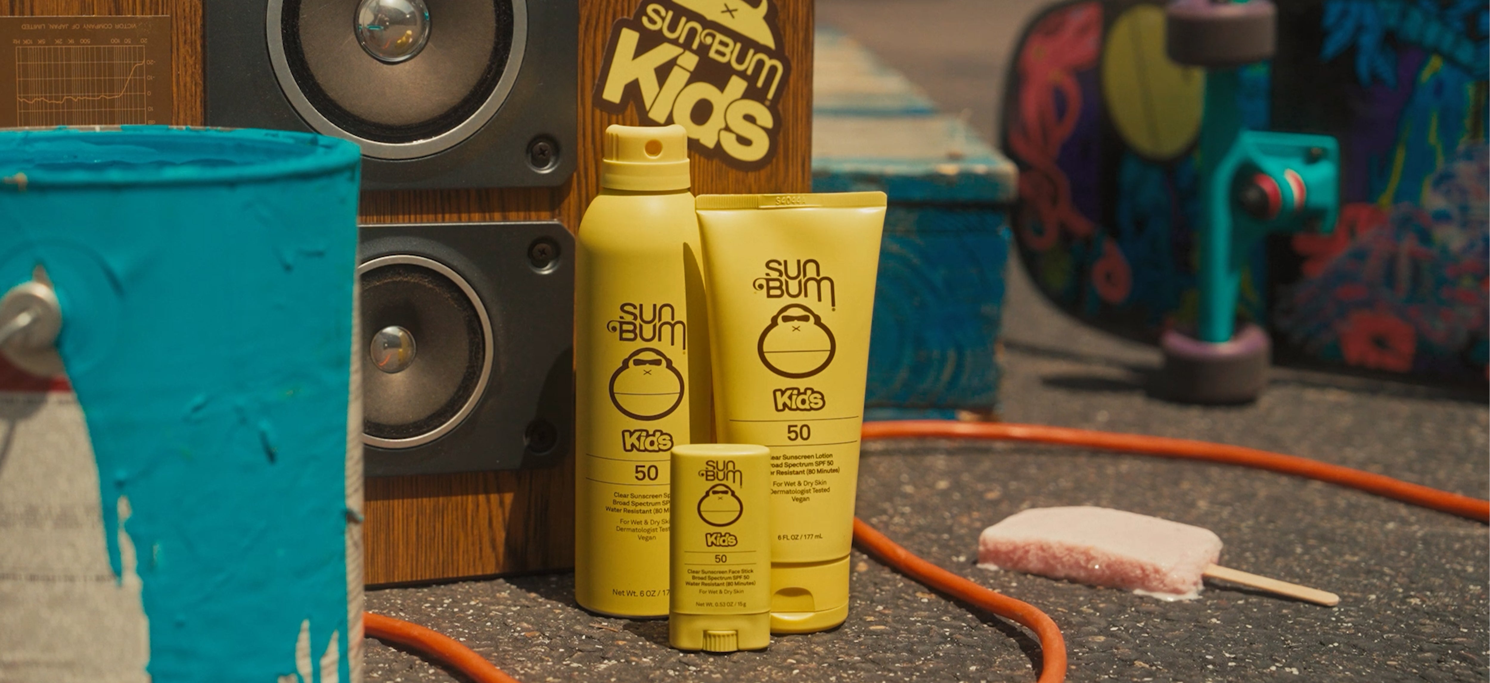 Sunbum Kids sunscreen bottles with a colorful background