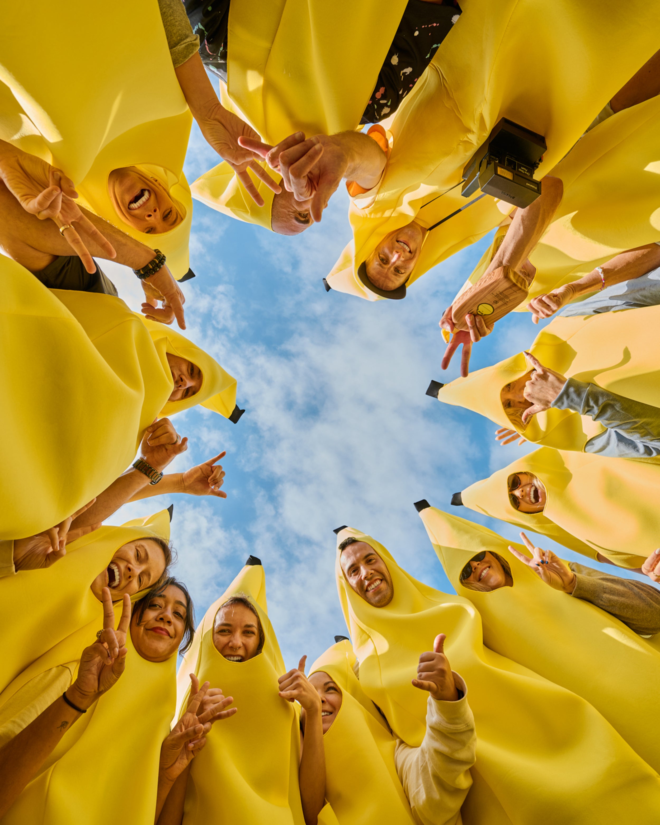 People wearing banana suits against a blue sky