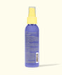 Purple spray bottle with yellow nozzle on a white background