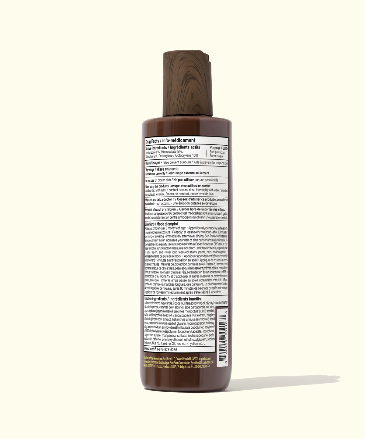 A dark brown bottle of hair product shown from the back, featuring a wood-grain cap and a white label with fine black text, set against a solid cream background.