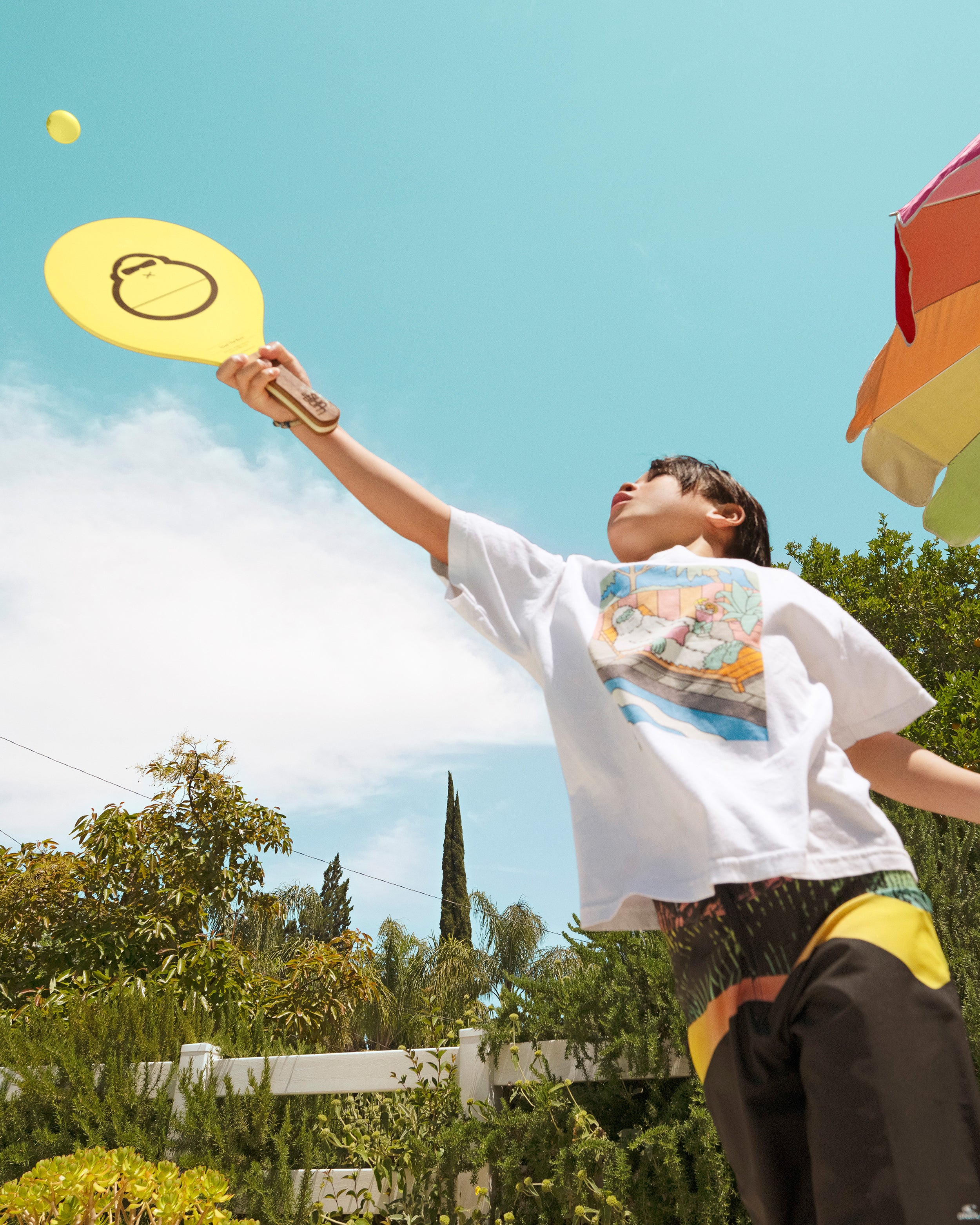 Person playing with a yellow disc in an outdoor setting