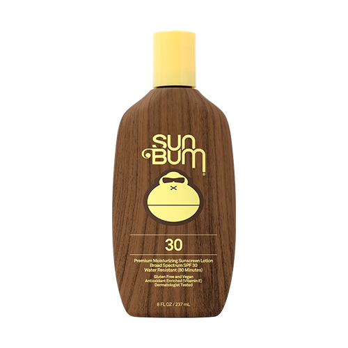 Sun Bum sunscreen bottle with wooden texture and yellow cap on a white background