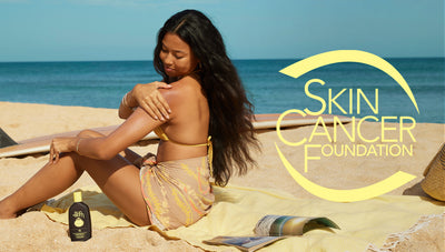Woman applying sunscreen on a beach with the Skin Cancer Foundation logo.