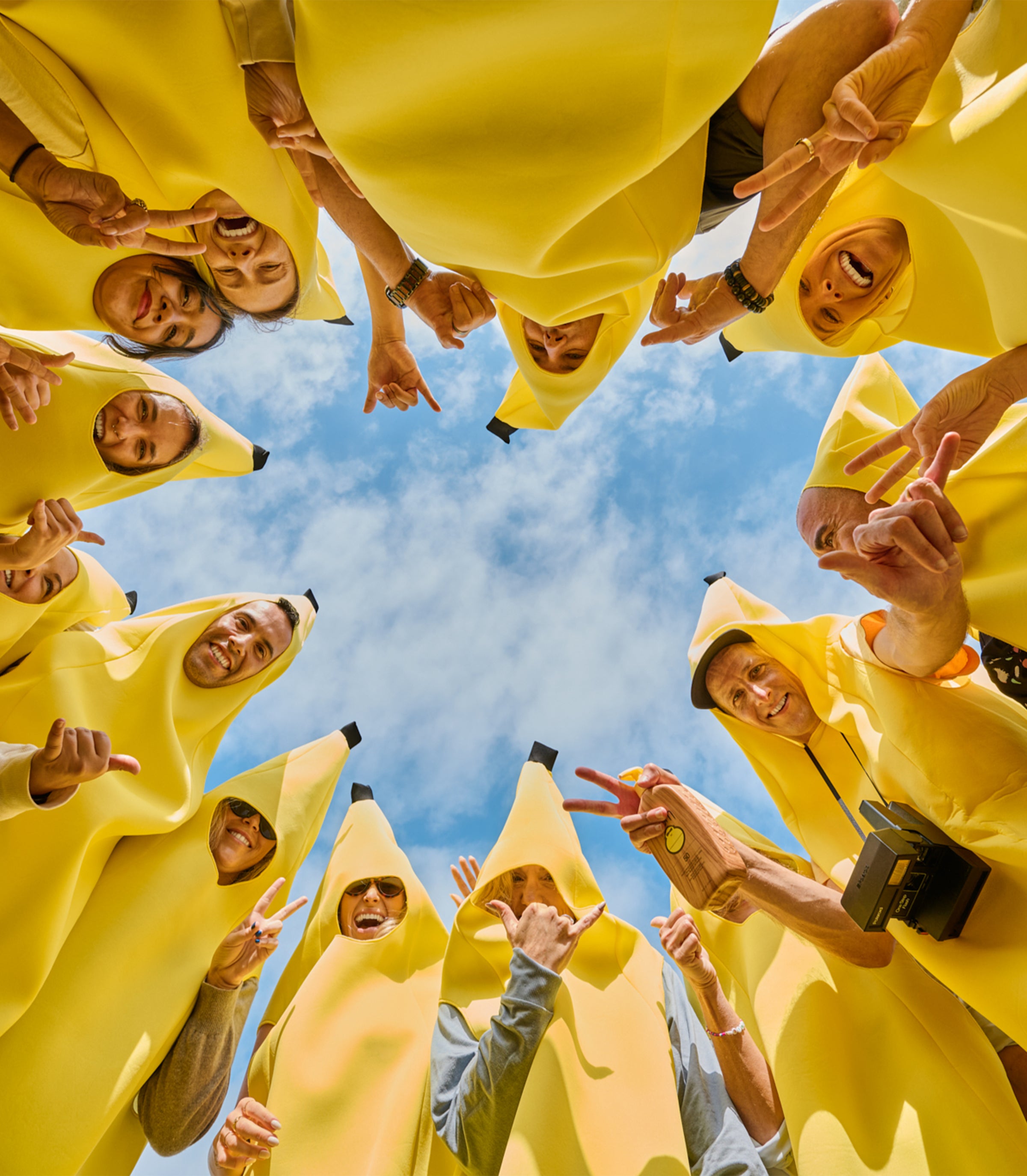 People wearing banana suits against a blue sky
