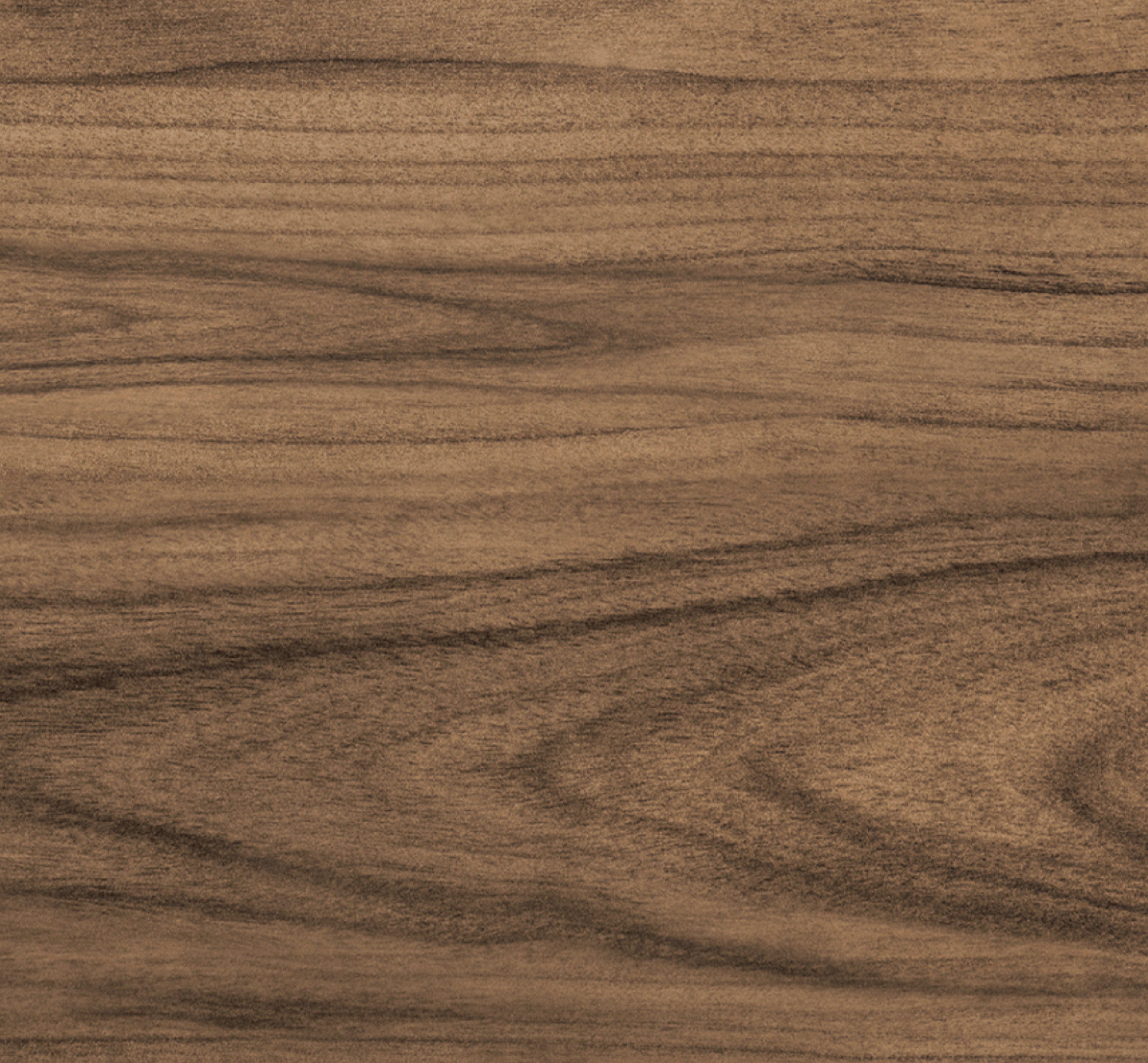Close-up of a wooden surface with a brown color and visible grain pattern.