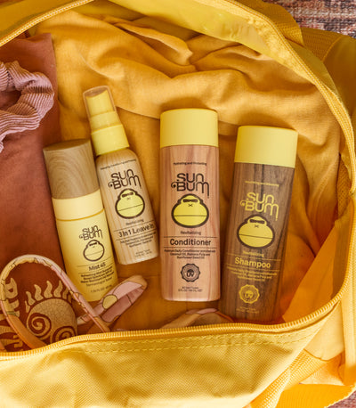 Sun Bum shampoo, conditioner, and lotion bottles in a yellow bag.